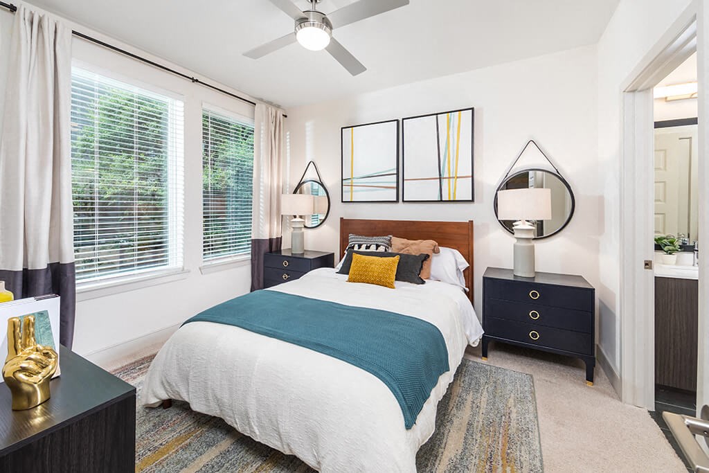 a bedroom with a bed and a ceiling fan