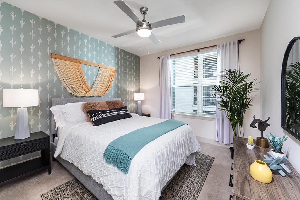 a bedroom with a bed and a ceiling fan