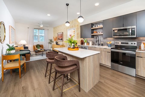 A modern kitchen with a dining table and chairs.