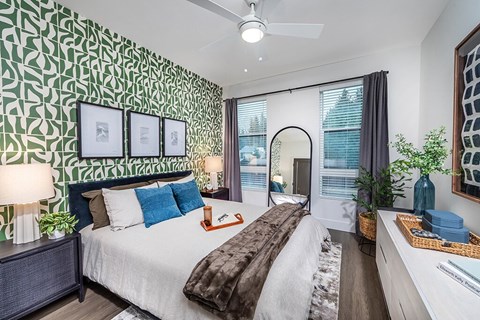 Bedroom with green accent wall at The Brynn in Kirkland WA