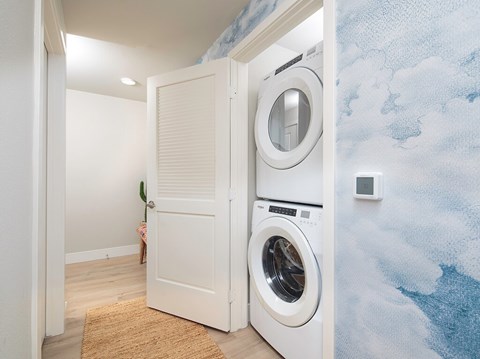 A white door with a washing machine behind it.