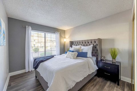 Bedroom with wood style flooring at Kaleidocope Apartment Homes in Las Vegas NV