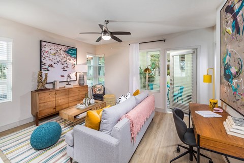 Sepia Design Package Living Room with ceiling fan at The Seaton Apartments in San Diego CA
