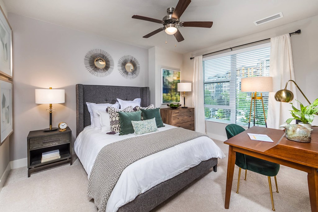 Bedroom with ceiling fan and window at Aspect at Totem Lake Apartments in Kirkland WA