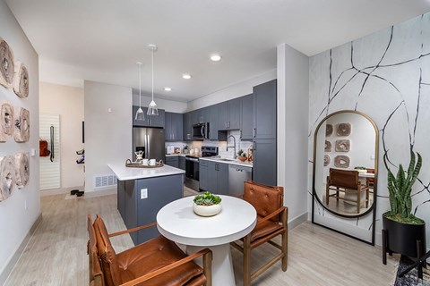 A modern kitchen with a dining table and chairs.