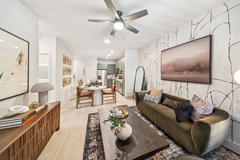 Model Snow Design Package Living Room and Kitchen at Olivean Apartments in Broomfield CO