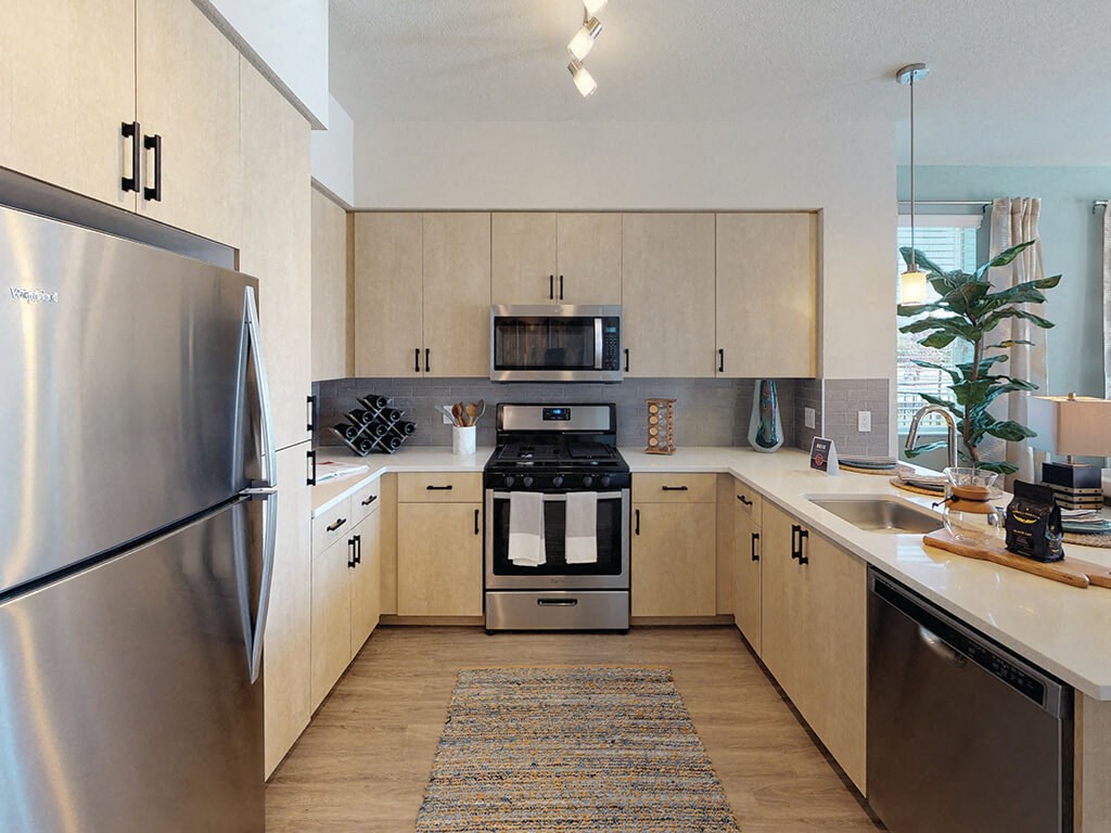 a kitchen with wooden cabinets and stainless steel appliances