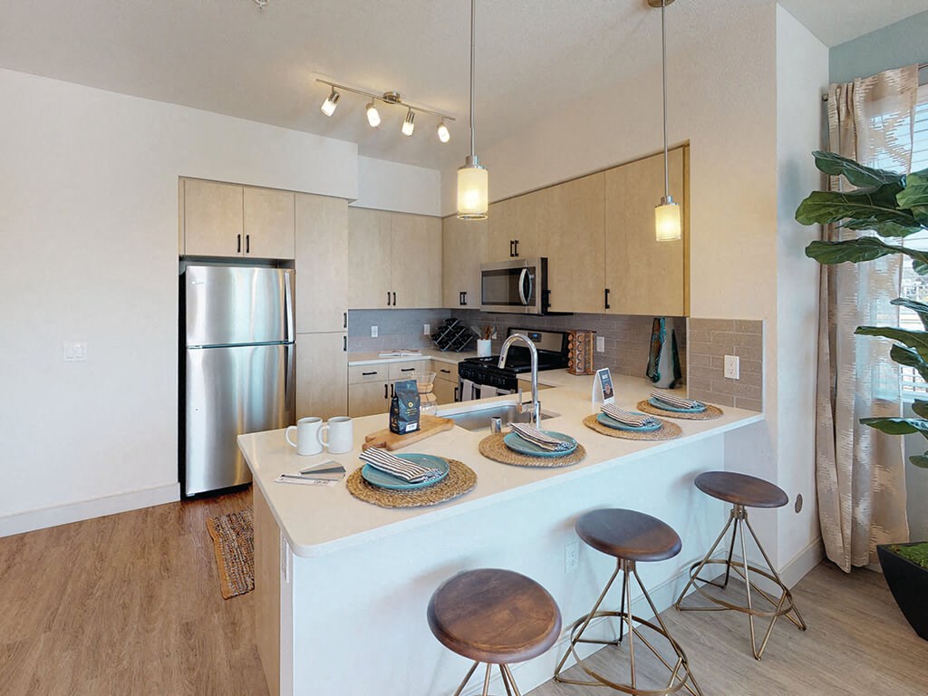 a kitchen with an island and stools
