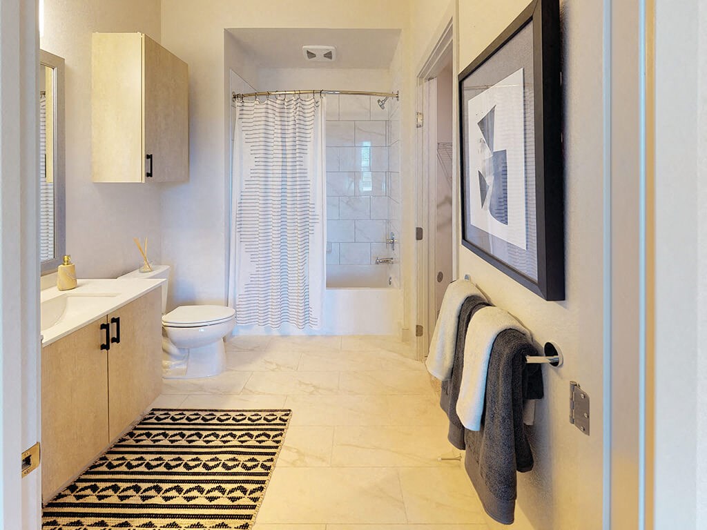 a bathroom with a toilet sink and shower