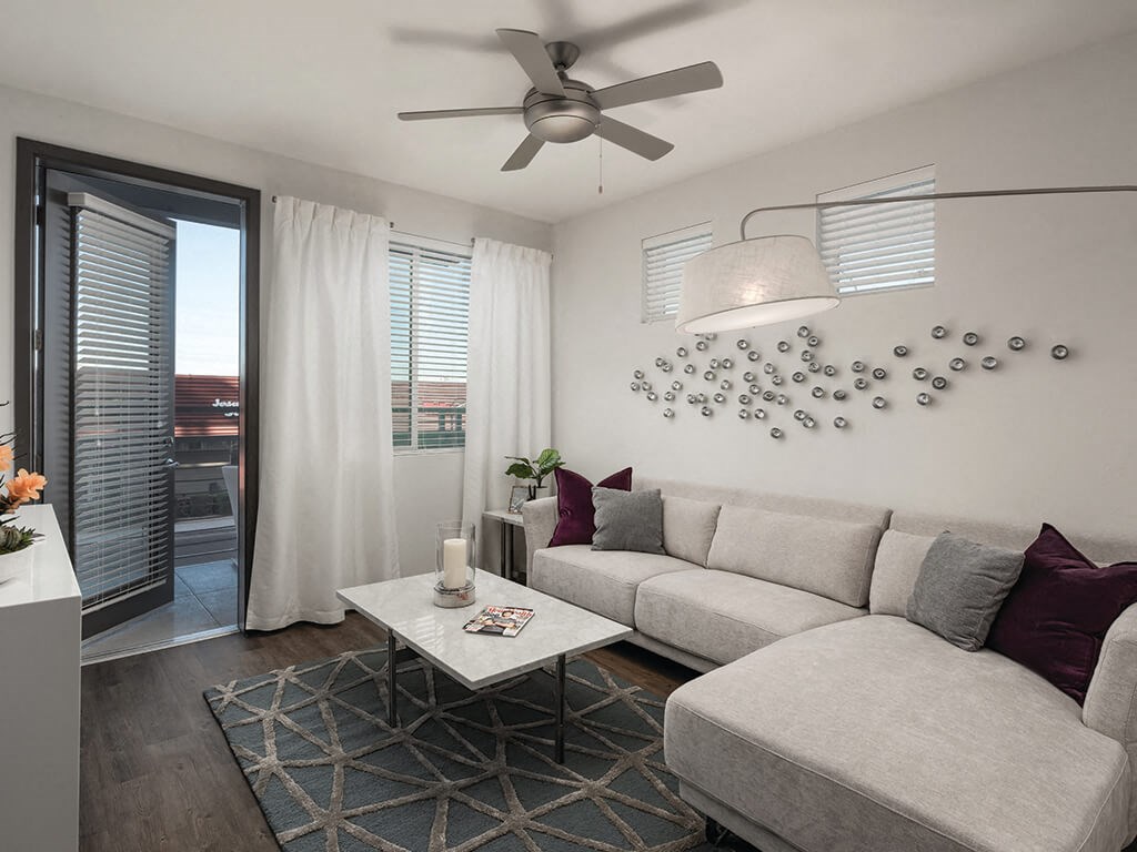 Model apartment living room with ceiling fan at Norte Town Lake Apartments in Tempe Arizona