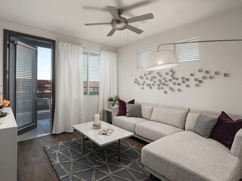 Model apartment living room with ceiling fan at Norte Town Lake Apartments in Tempe Arizona