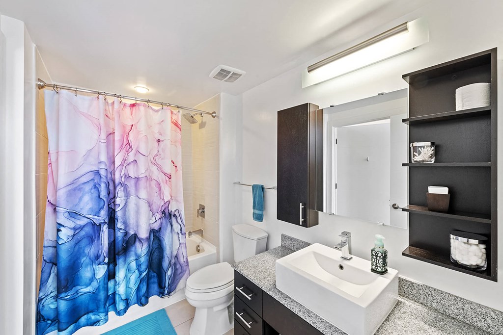 Bathroom with shelving at Bradley Braddock Road Station Apartments in Alexandria VA