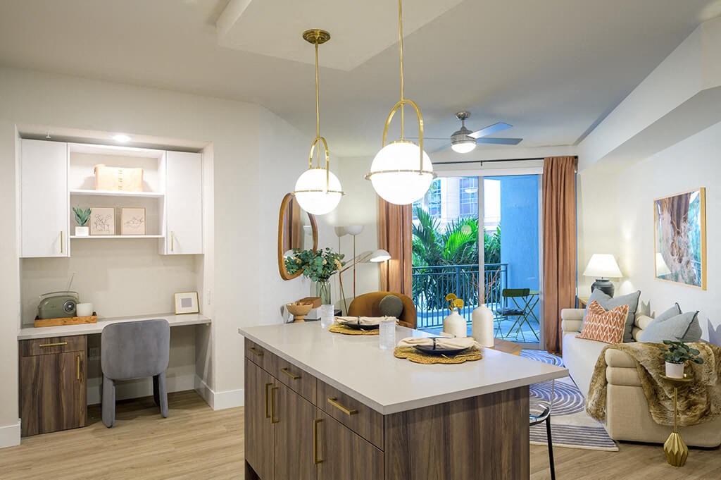 Model kitchen and built-in desk at Coasterra Apartments in Fort Lauderdale FL