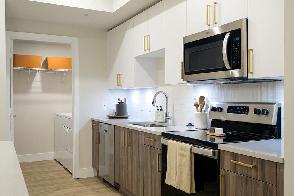 Model kitchen and washer and dryer at Coasterra Apartments in Fort Lauderdale FL