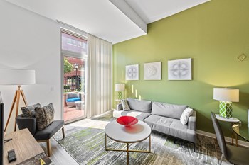 Living room with walk out balcony at Bradley Braddock Road Station Apartments in Alexandria VA - Photo Gallery 6