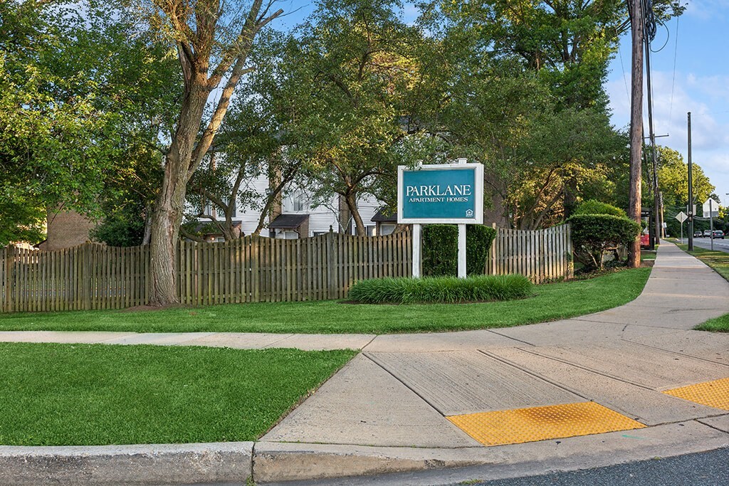 a street sign sitting on the side of a sidewalk