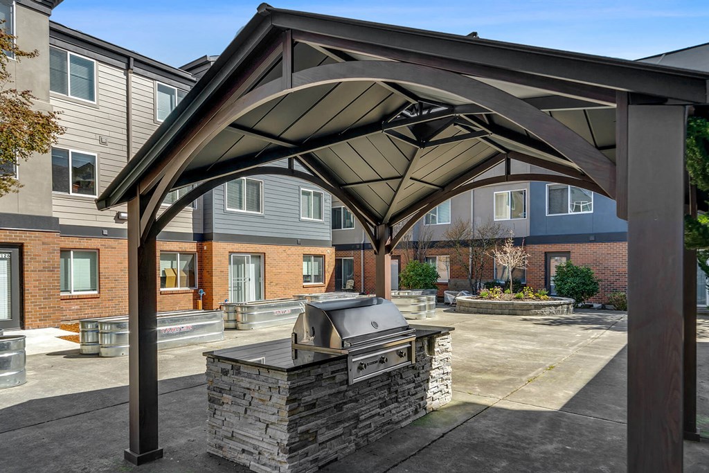 Outdoor patio with grill at Auburn Court Apartments in Auburn WA