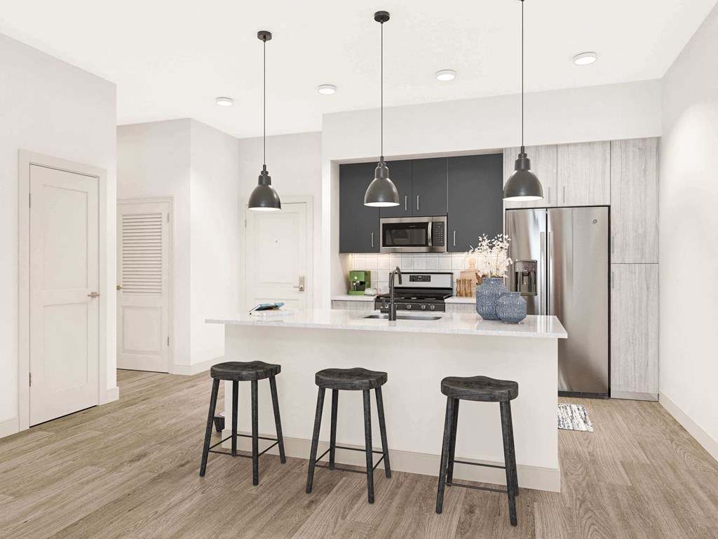 a kitchen with a large island with three stools