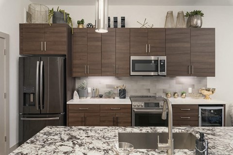 Penthouse Kitchen with dark wood cabinets at District at Scottsdale Apartments in Scottsdale AZ