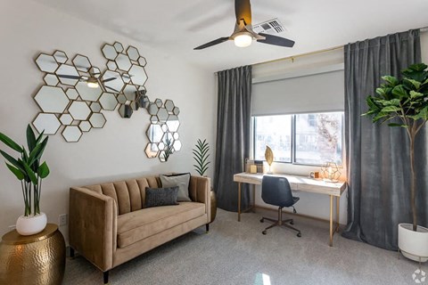 Penthouse living room with ceiling fan at District at Scottsdale Apartments in Scottsdale AZ