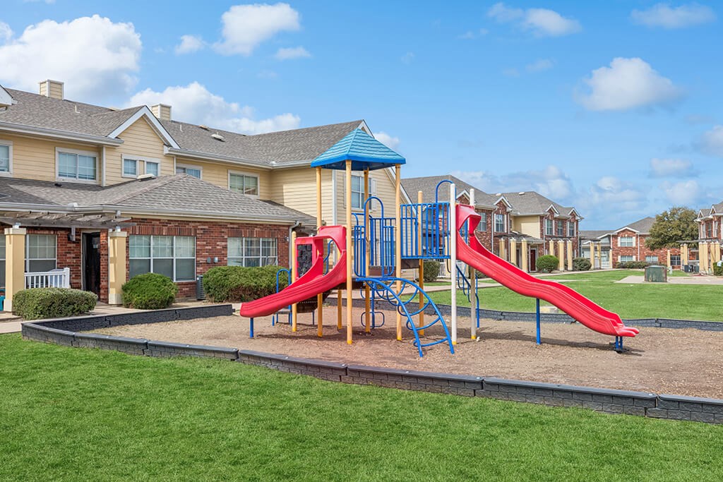 Outdoor playground at Ironwood Crossing Apartments and Townhomes in Fort Worth TX
