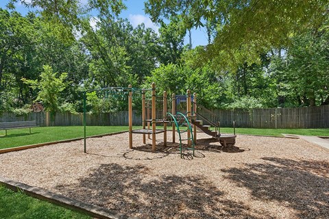 a playground with a swing set in a park