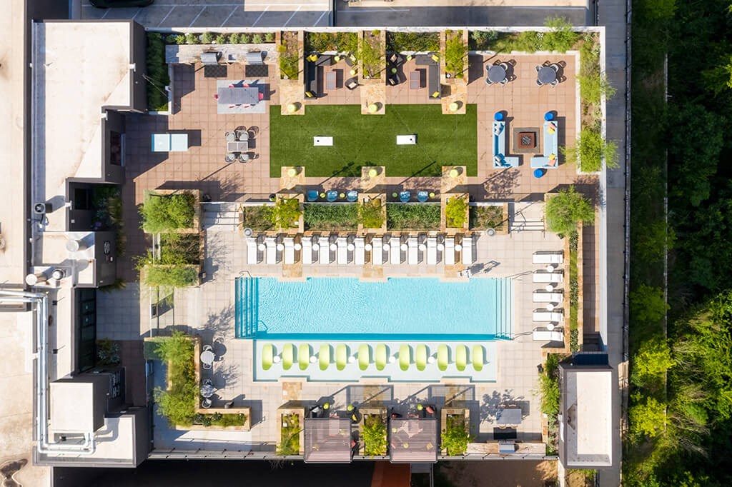 a birds eye view of the roof of a building with a pool