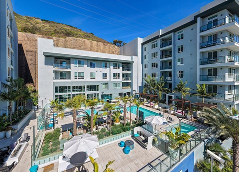 A large white building with a pool and patio area.