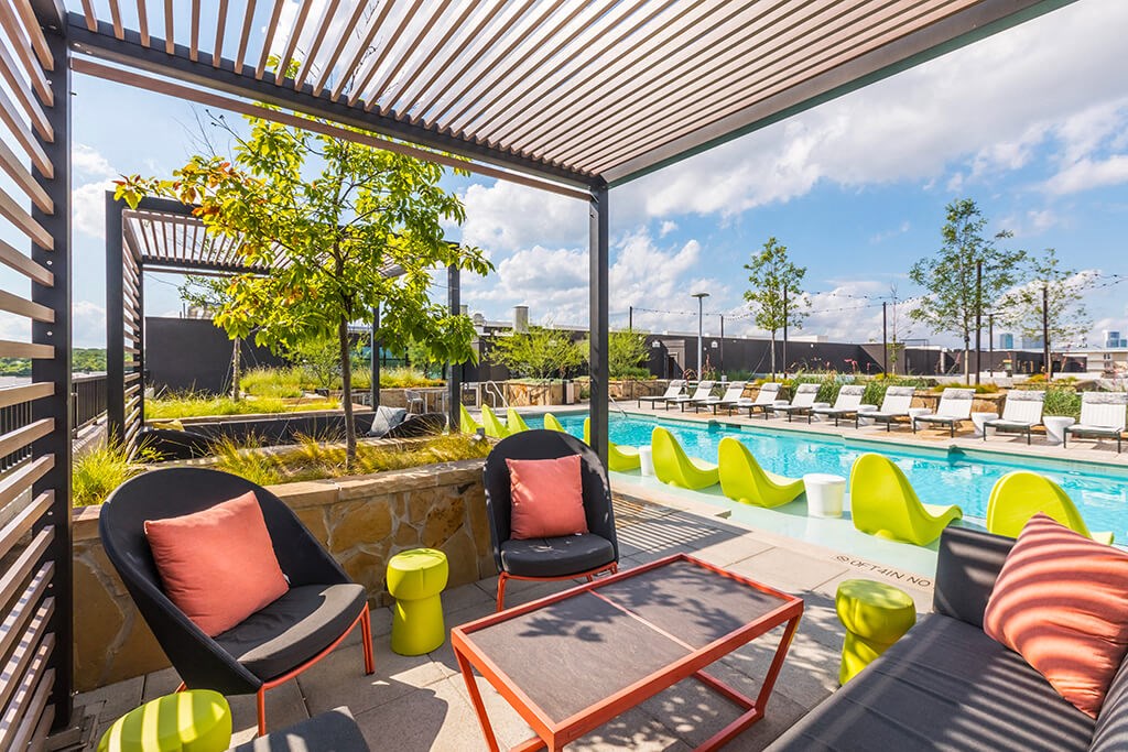 a swimming pool with lounge chairs and a patio