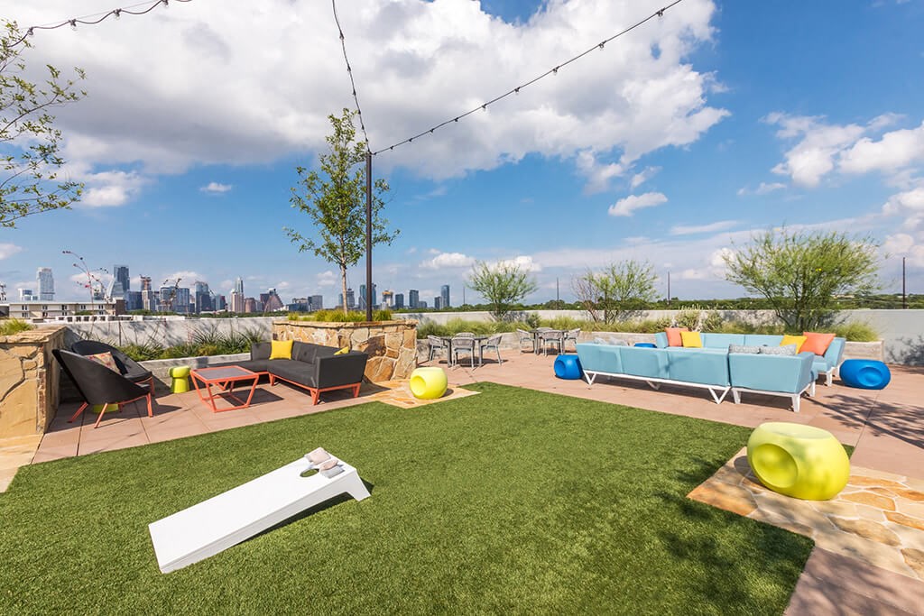 a rooftop lounge area with a view of the city