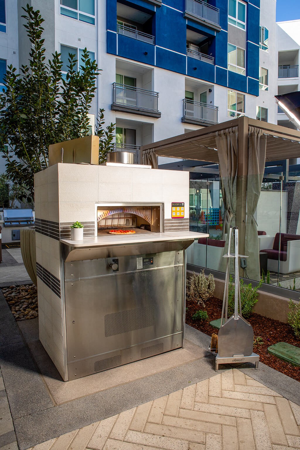 Pool Luminescence Pizza Oven with Pizza at Chroma Apartment Homes in Canoga Park CA