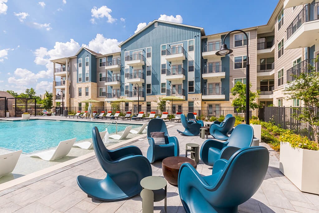 Pool rocking chairs at 1900 Parmer Apartments in Austin TX