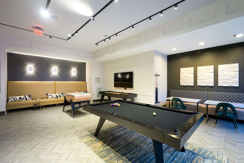 Game room with a pool table and a television at The Moxley in Fairfax VA