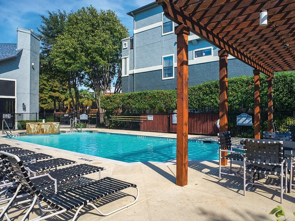 North Dallas TX Apartments - Tivoli Apartments - Relaxing Pool wth Lounge Chairs, Pergola, Table and Chairs