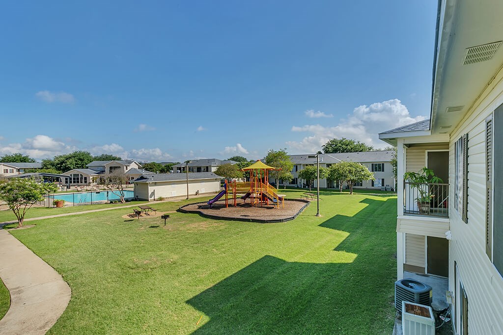 Pool and playground at Paradise Oaks apartments in Austin TX