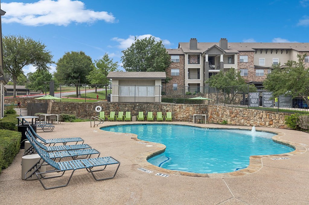 Pool with lounge chairs at Cypress View Villa Apartments in Weatherford TX