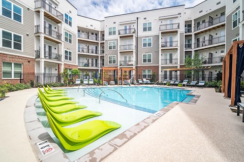 Outdoor pool and tanning chairs at The Belhaven in Alexandria VA