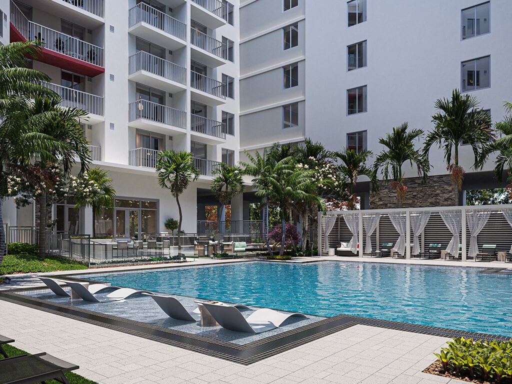 Large swimming pool and sun lounge chairs at Treo Apartments in Fort Lauderdale FL