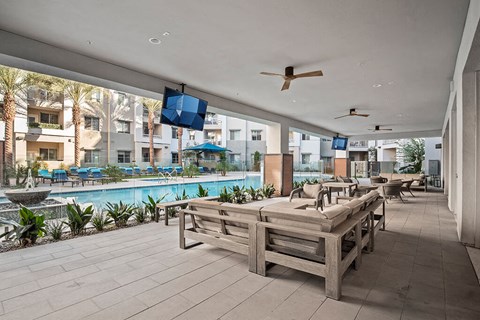 Poolside tv and seating at District at Scottsdale Apartments in Scottsdale AZ