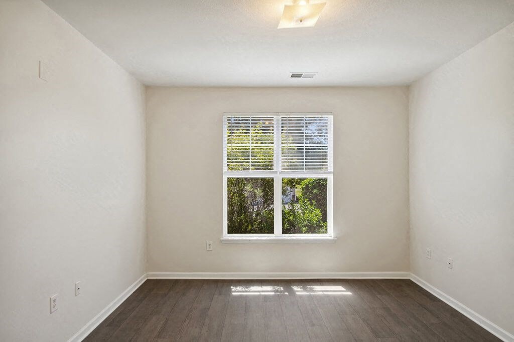 Primary Bedroom with window at Magnolia Pointe Apartments in Durham NC