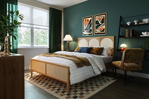 A bedroom with a bed, chair, and lamp.