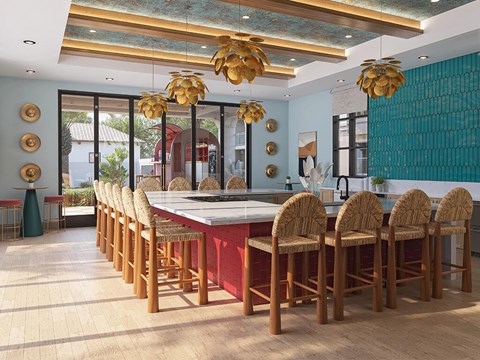 A kitchen with a long table and chairs.