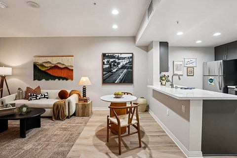 A modern kitchen with a dining table and chairs in the middle of the room.