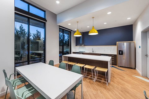 a kitchen and dining room with a table and chairs