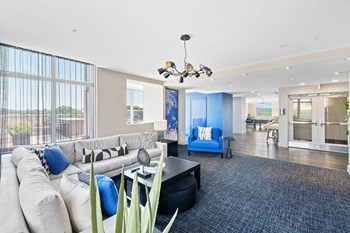 Resident clubhouse couches at Bradley Braddock Road Station Apartments in Alexandria VA - Photo Gallery 15