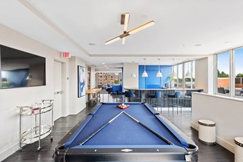 Resident clubhouse billiards table at Bradley Braddock Road Station Apartments in Alexandria VA - Photo Gallery 14
