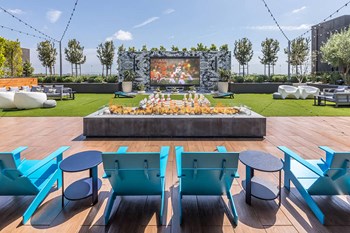 Rooftop Lounge Exhale Fire Table and Theatre at Aura Apartment Homes in Orange CA - Photo Gallery 13