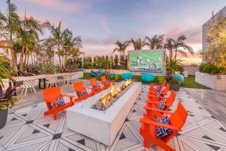 Rooftop Vantage Fire Table and Theater Wall at Dusk at Vita Apartment Homes in Orange, CA