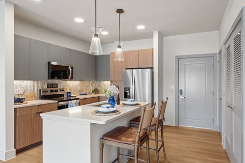 A modern kitchen with a dining table and chairs.