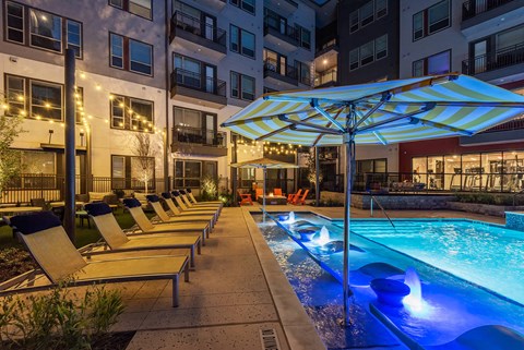 Shallow water pool at night at Opal Legacy Central in Plano TX